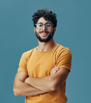 man smiling with glasses and organge shirt